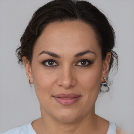 Joyful latino young-adult female with medium  brown hair and brown eyes