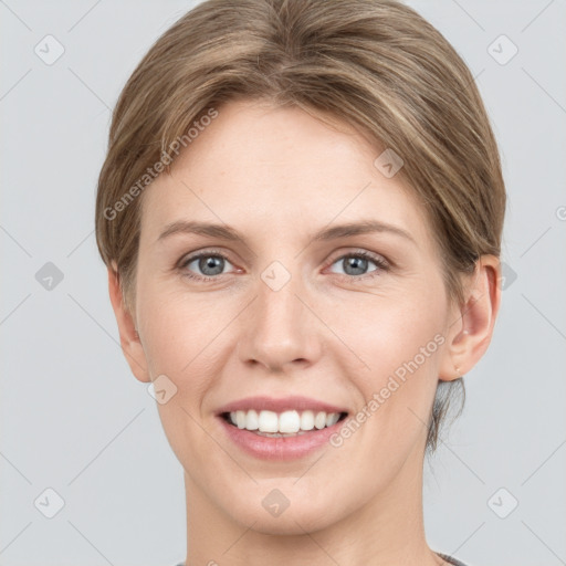 Joyful white young-adult female with short  brown hair and grey eyes