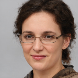 Joyful white adult female with medium  brown hair and brown eyes