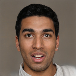 Joyful latino young-adult male with short  black hair and brown eyes