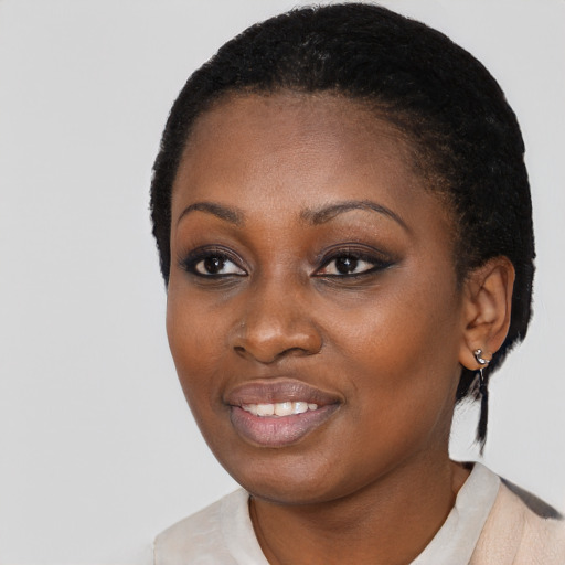 Joyful black young-adult female with short  black hair and brown eyes