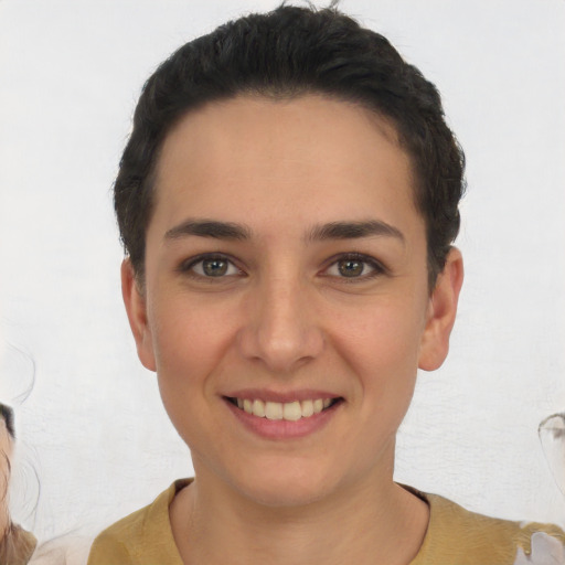 Joyful white young-adult female with short  black hair and brown eyes