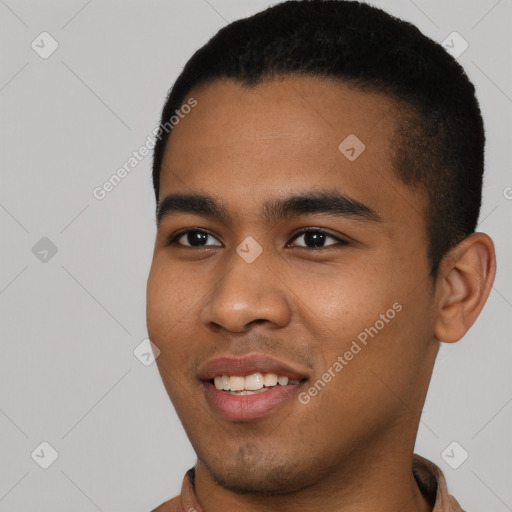 Joyful black young-adult male with short  black hair and brown eyes