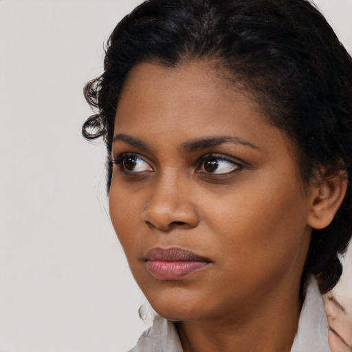 Joyful black young-adult female with medium  black hair and brown eyes