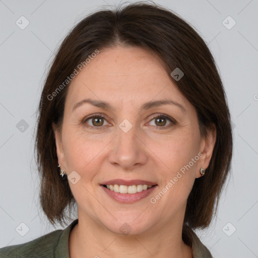 Joyful white adult female with medium  brown hair and grey eyes