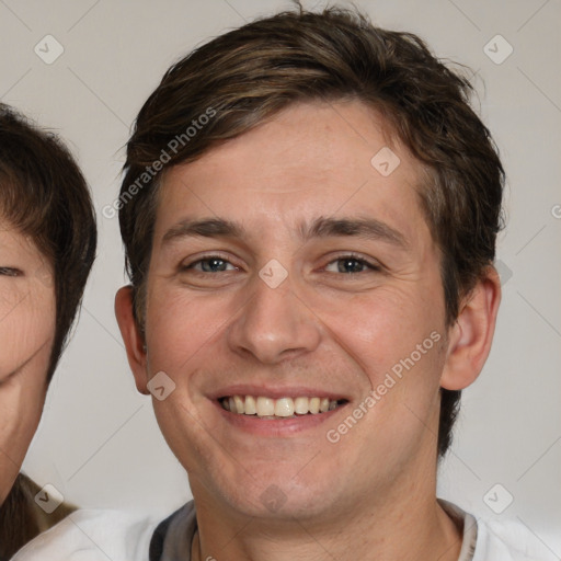 Joyful white adult male with short  brown hair and brown eyes