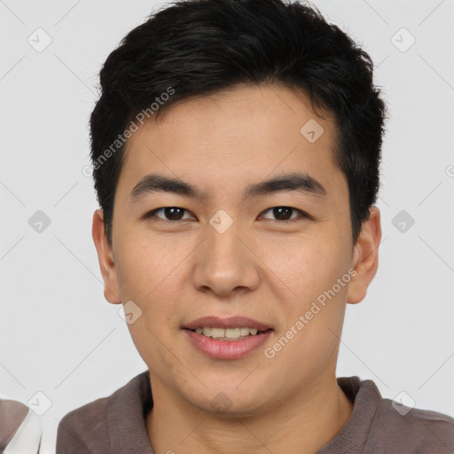 Joyful asian young-adult male with short  brown hair and brown eyes