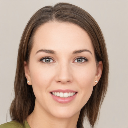 Joyful white young-adult female with medium  brown hair and grey eyes