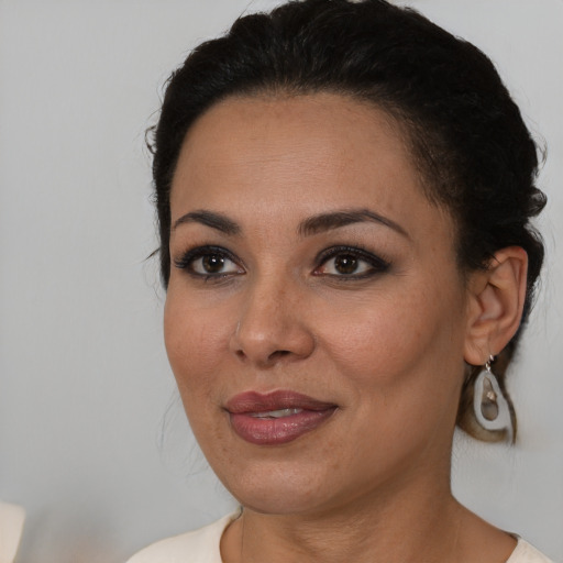 Joyful latino young-adult female with medium  black hair and brown eyes