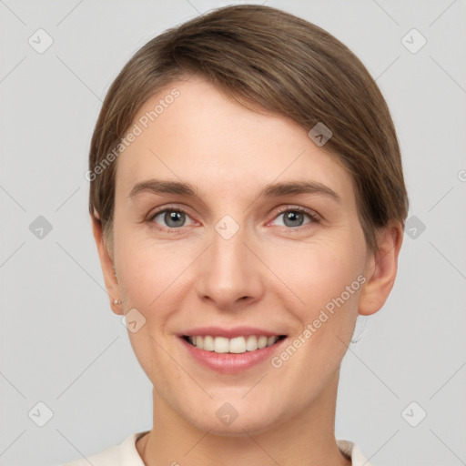 Joyful white young-adult female with short  brown hair and grey eyes