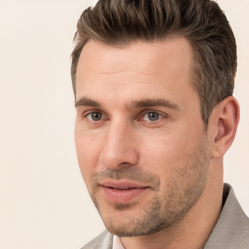 Joyful white adult male with short  brown hair and brown eyes