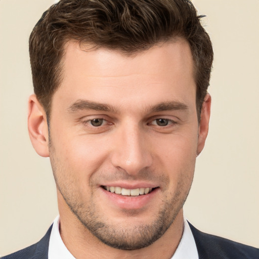 Joyful white young-adult male with short  brown hair and brown eyes