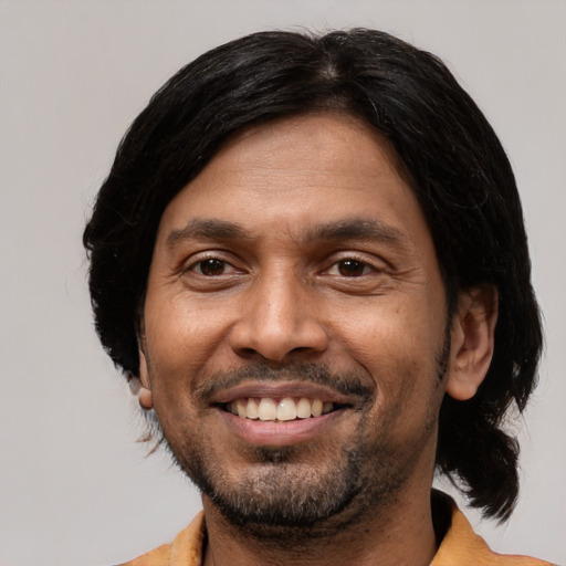 Joyful latino adult male with short  black hair and brown eyes