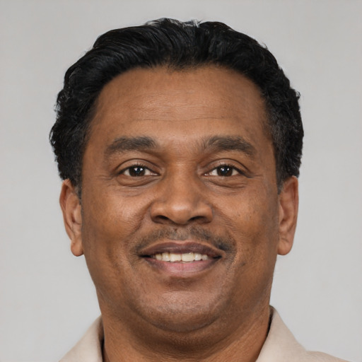 Joyful latino adult male with short  black hair and brown eyes