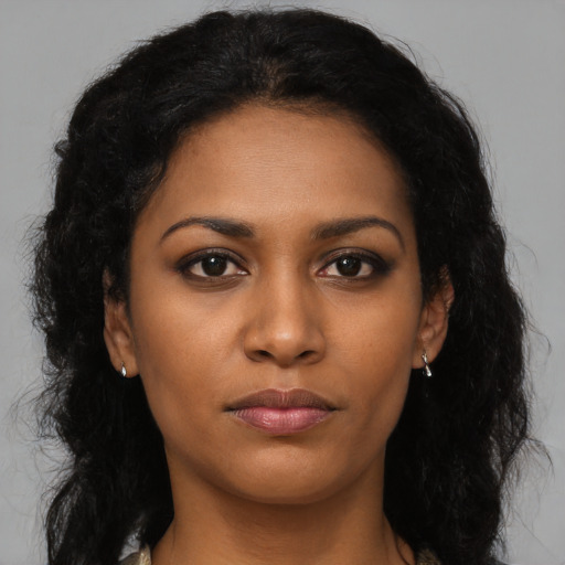 Neutral black young-adult female with long  brown hair and brown eyes
