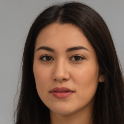 Joyful latino young-adult female with long  brown hair and brown eyes