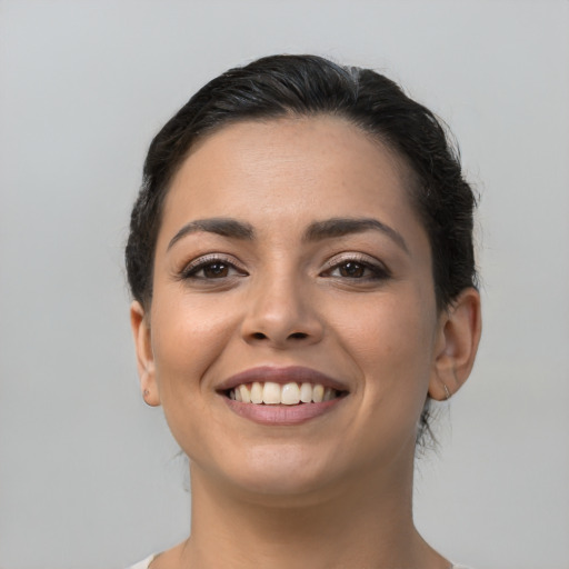 Joyful latino young-adult female with long  black hair and brown eyes