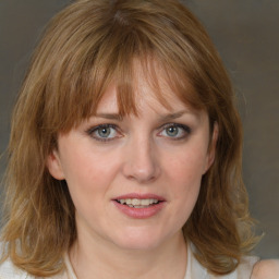 Joyful white young-adult female with medium  brown hair and blue eyes