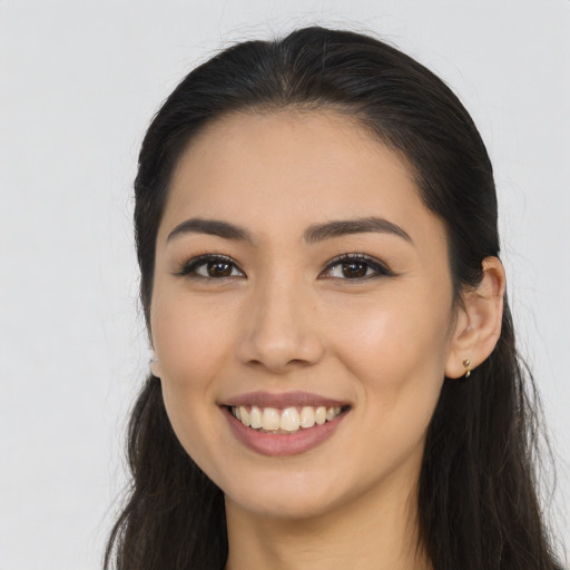 Joyful asian young-adult female with long  brown hair and brown eyes