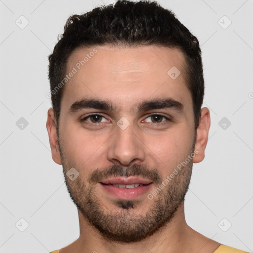 Joyful white young-adult male with short  black hair and brown eyes