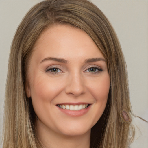 Joyful white young-adult female with long  brown hair and brown eyes