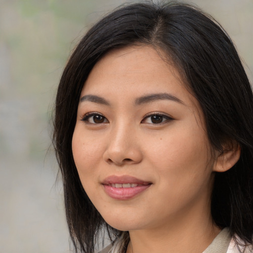 Joyful asian young-adult female with medium  brown hair and brown eyes