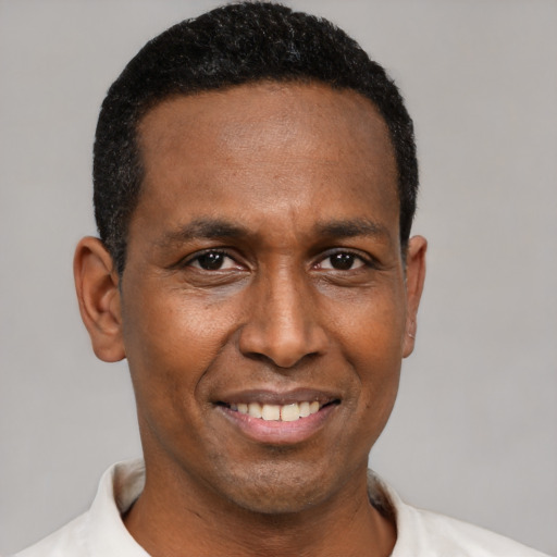 Joyful latino adult male with short  black hair and brown eyes