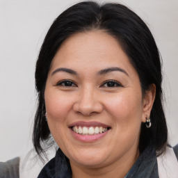 Joyful white adult female with medium  brown hair and brown eyes