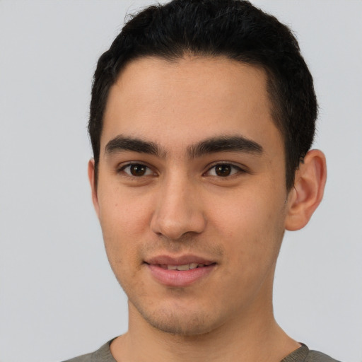 Joyful white young-adult male with short  black hair and brown eyes