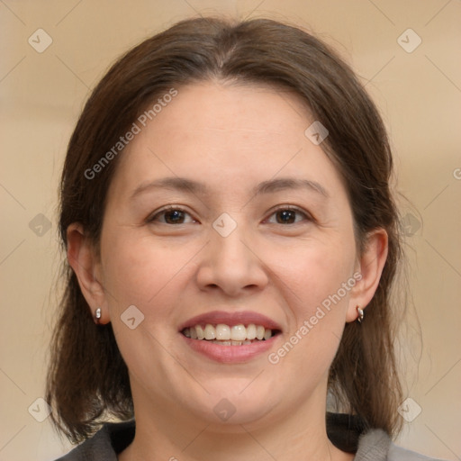 Joyful white adult female with medium  brown hair and brown eyes