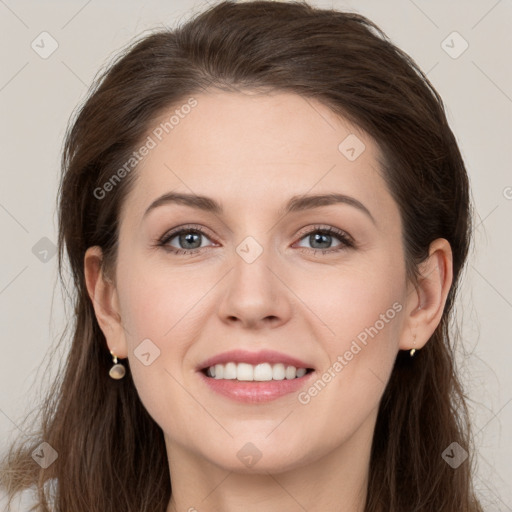 Joyful white young-adult female with long  brown hair and grey eyes