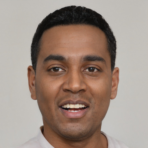 Joyful black young-adult male with short  black hair and brown eyes