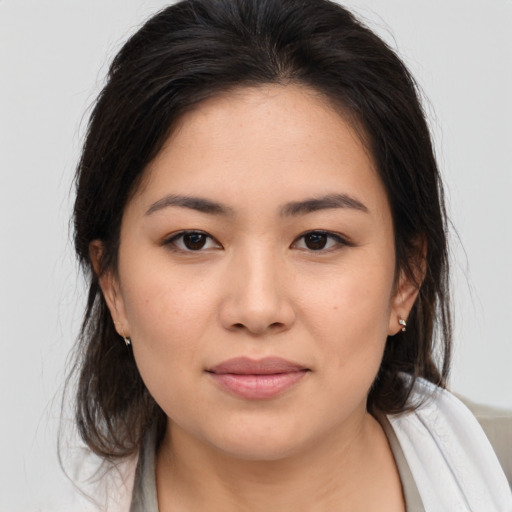 Joyful asian young-adult female with medium  brown hair and brown eyes