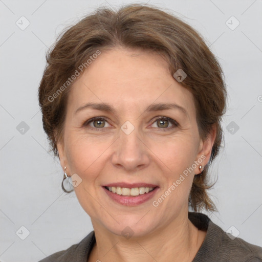 Joyful white adult female with medium  brown hair and grey eyes