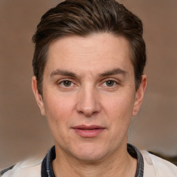 Joyful white adult male with short  brown hair and grey eyes