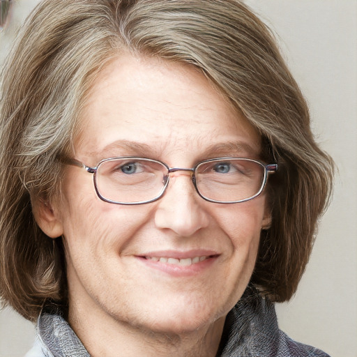 Joyful white middle-aged female with medium  brown hair and blue eyes