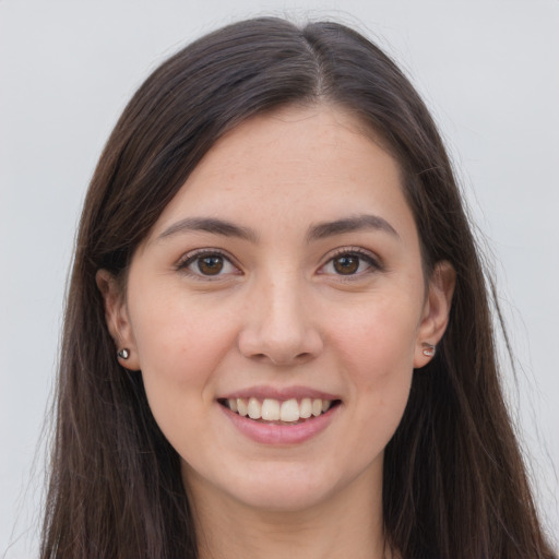 Joyful white young-adult female with long  brown hair and grey eyes