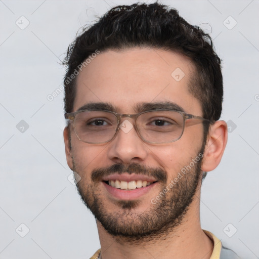 Joyful white young-adult male with short  black hair and brown eyes