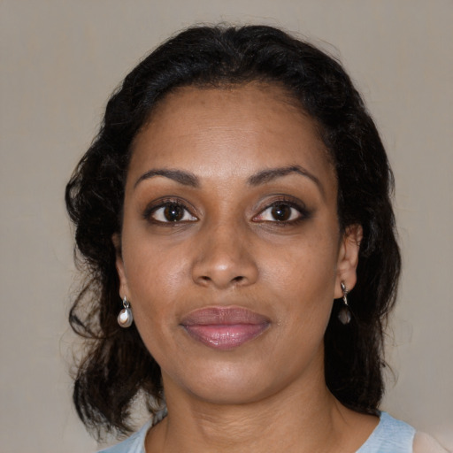 Joyful black young-adult female with medium  brown hair and brown eyes