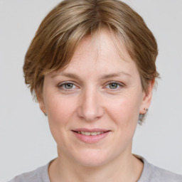 Joyful white adult female with medium  brown hair and grey eyes