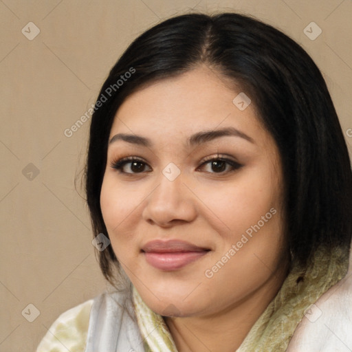 Joyful latino young-adult female with medium  brown hair and brown eyes