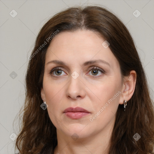 Joyful white adult female with long  brown hair and grey eyes