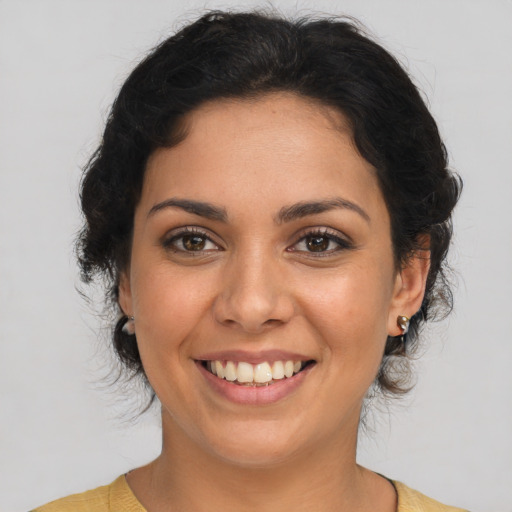 Joyful latino young-adult female with medium  brown hair and brown eyes