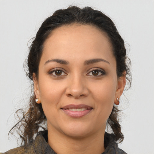 Joyful latino young-adult female with medium  brown hair and brown eyes