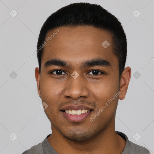 Joyful black young-adult male with short  black hair and brown eyes