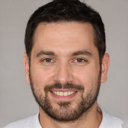 Joyful white young-adult male with short  brown hair and brown eyes