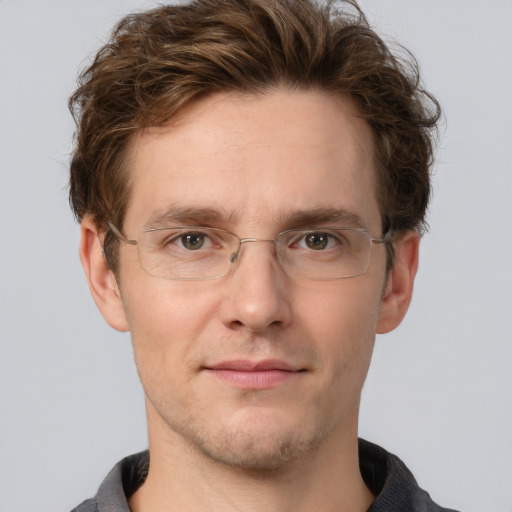 Joyful white adult male with short  brown hair and grey eyes