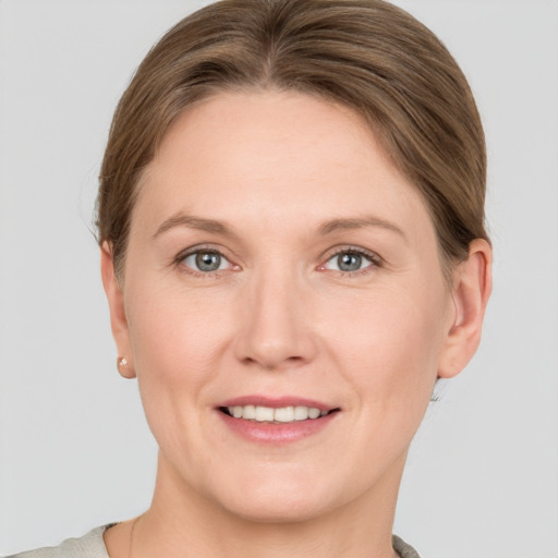 Joyful white adult female with short  brown hair and grey eyes