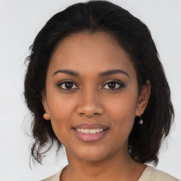 Joyful latino young-adult female with medium  brown hair and brown eyes