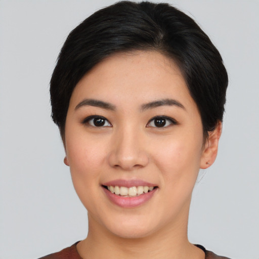 Joyful asian young-adult female with short  black hair and brown eyes